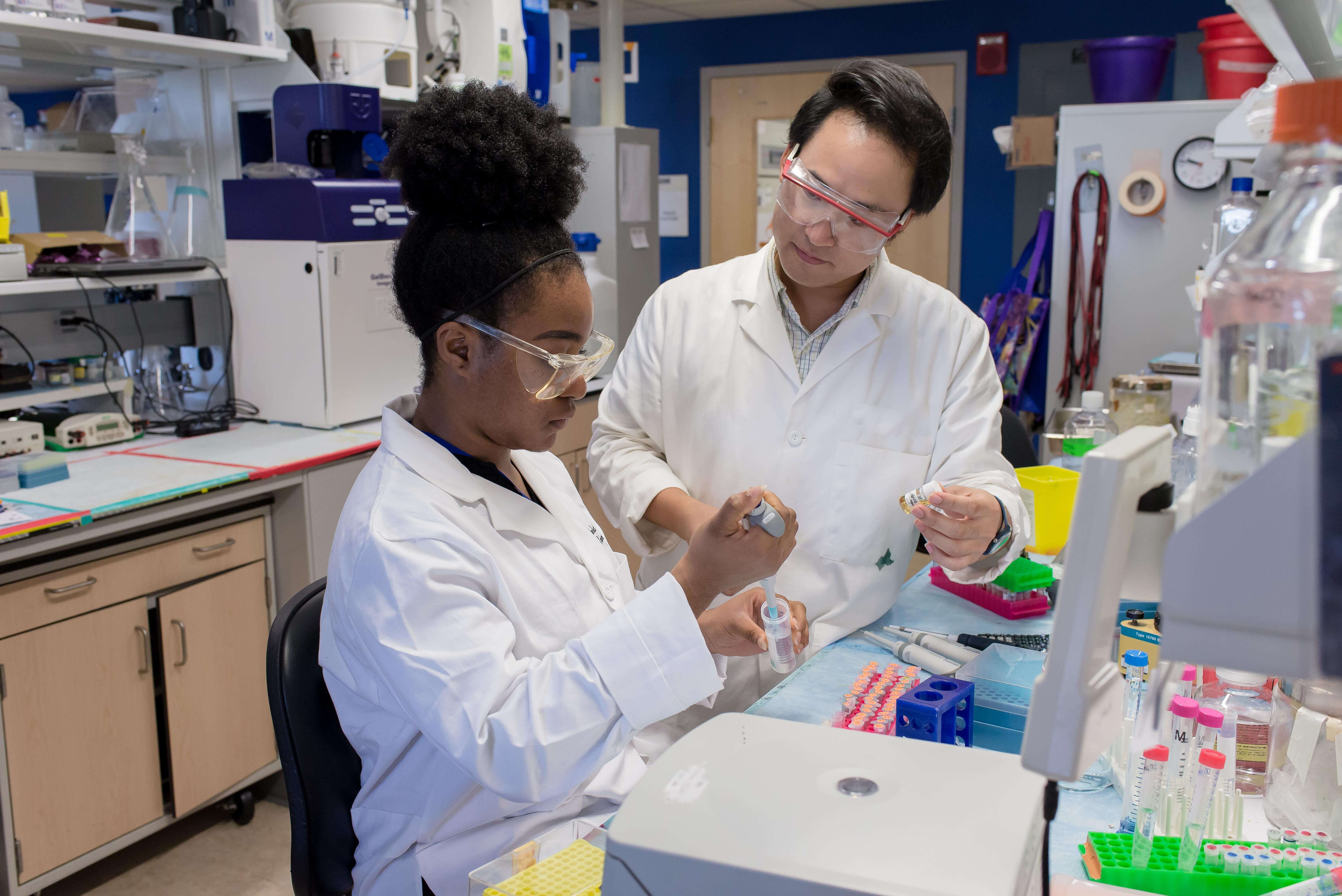 Two researchers in a lab conducting an experiment