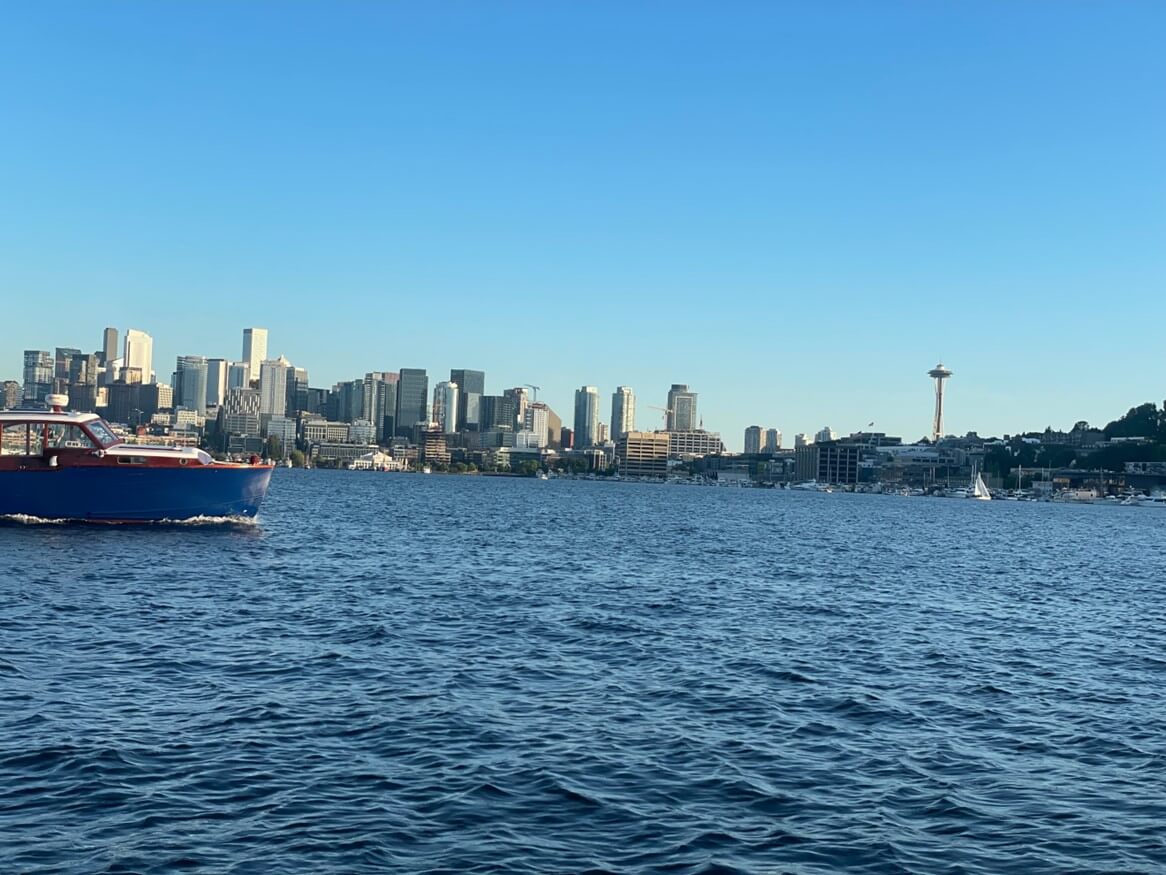 Boat in the water of Lake Union with view of Seattle cityscape in the background